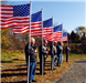 Six veteran's standing with the American Flag