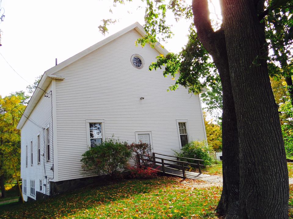 White home with a mature tree in the front