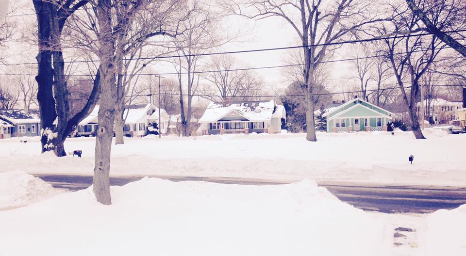 Sepia photography of homes surrounded by snow
