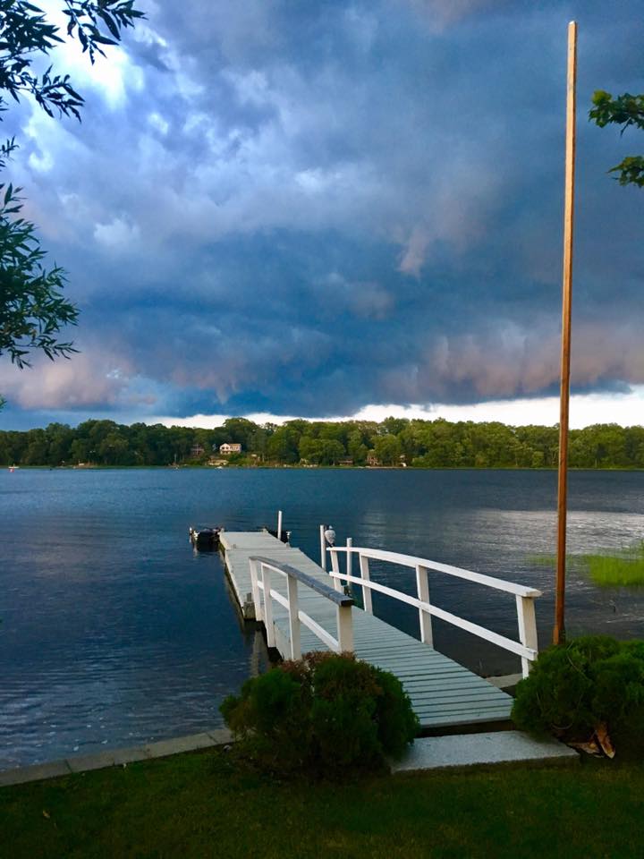 Dock on the lake overlooking storm clouds